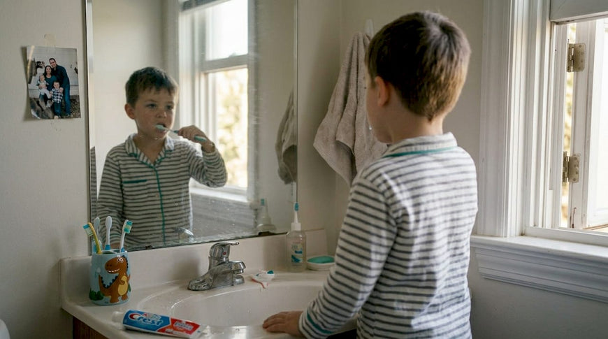 Boy brushing teeth in lived-in family bathroom