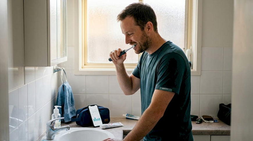 Man brushing teeth using smart toothbrush app