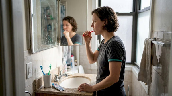 Person brushing teeth during daily routine