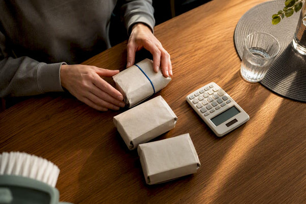 Hands planning annual toothbrush subscription costs