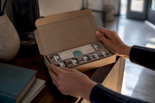 Hands opening a replacement brush shipment