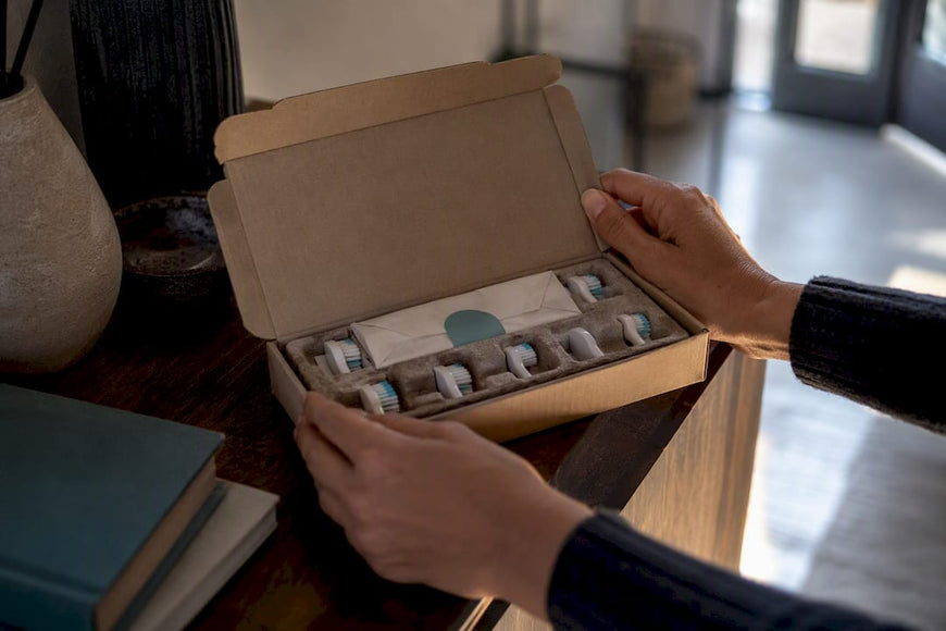 Hands opening a replacement brush shipment