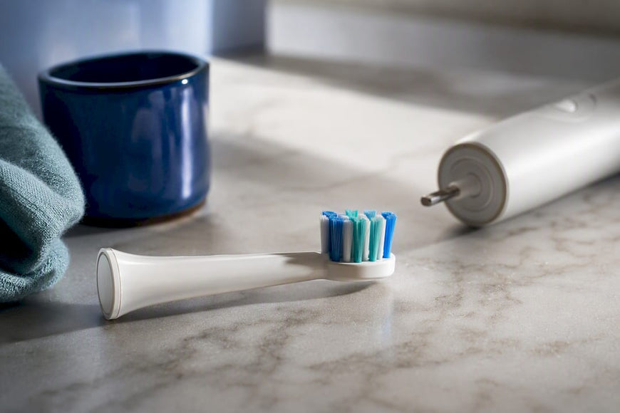 Cropped toothbrush head beside handle