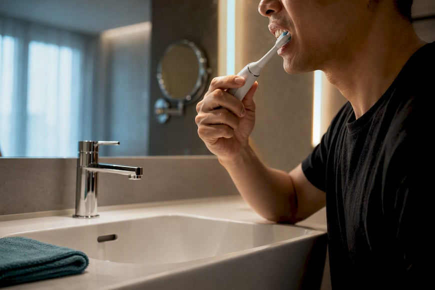 Adult gently guiding powered toothbrush