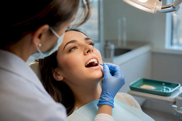 Clinician applying fluoride varnish treatment