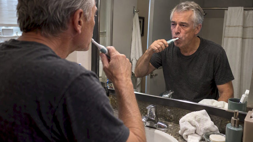 Man brushing with a sonic toothbrush