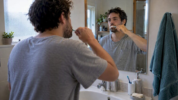 Adult brushing teeth in the morning