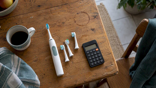 Electric toothbrush, replacement heads, and calculator